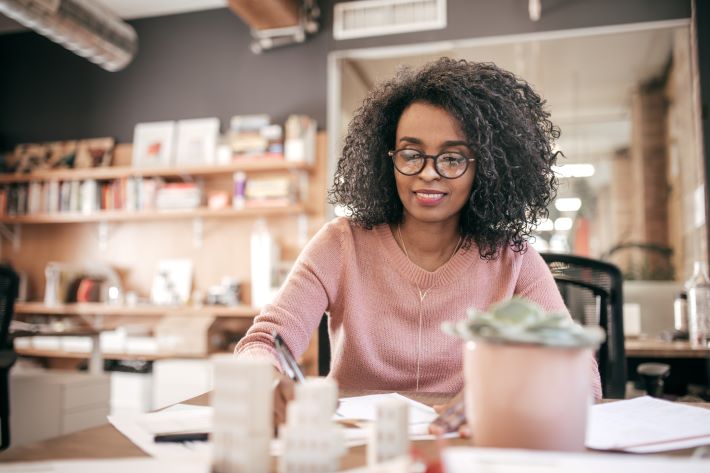 Sitting woman completing forms Sitting woman completing forms