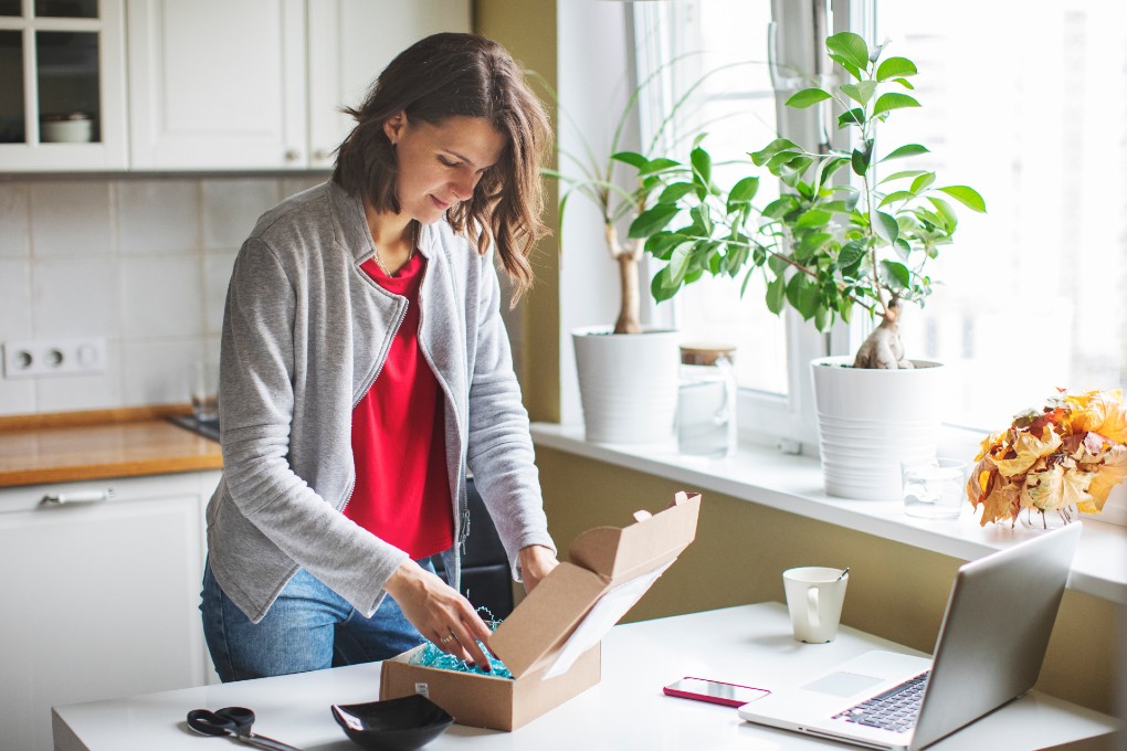 Woman opening a defective package she’ll get a refun for