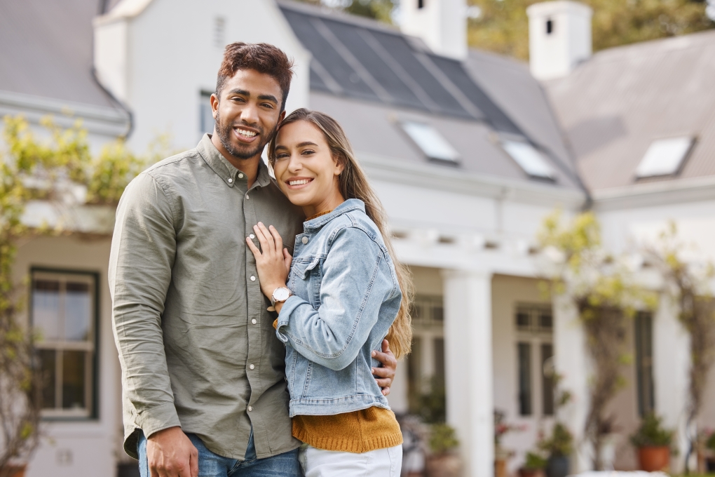 Portrait, a smiling couple outside their new home, bonding and having fun together.