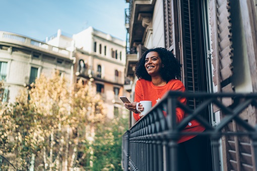 Woman outside on her balcony looking at the view