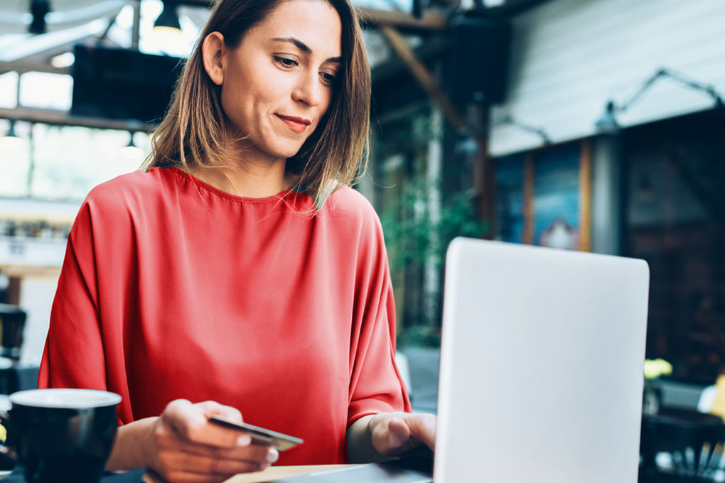 Women looking at her credit card statement on a laptop