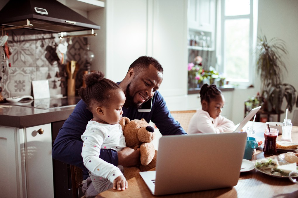 Image of family in front of computer in the kitchen