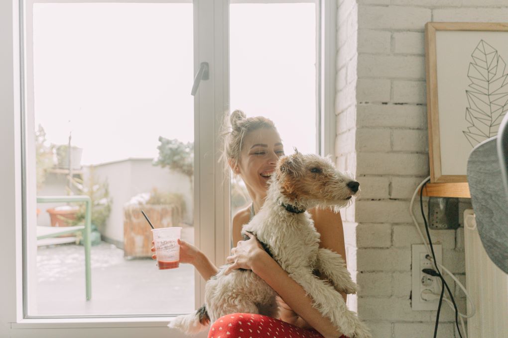 Photo of a young woman with her dog for an article about emergency fund