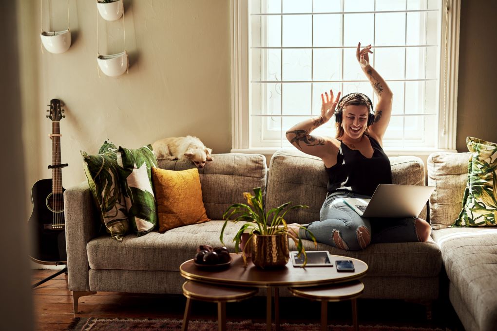 Photo of a young woman smiling in her home for an article about insurance