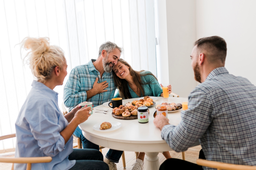 image of a family at the table for an article about helping a loved one become a homeowner 