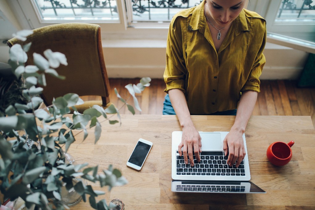 A female accountant reviews tax documents to prepare her company’s taxes.