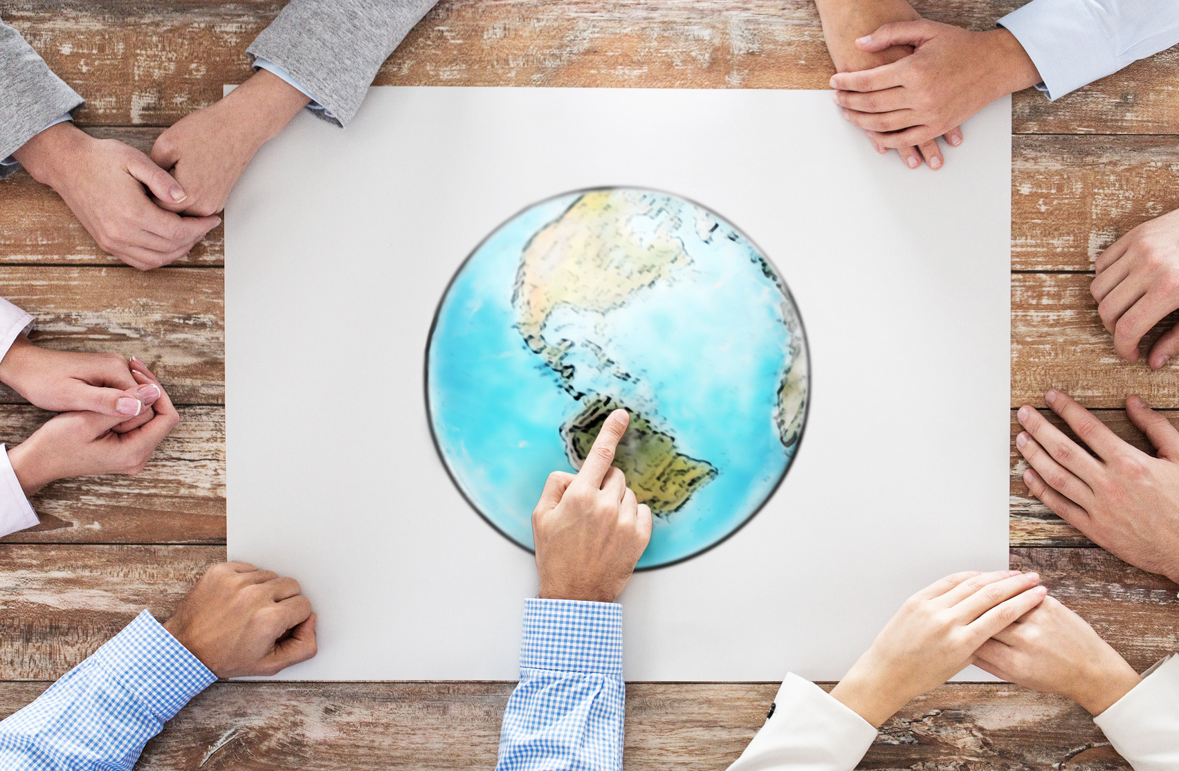 close up of hands with globe picture at table