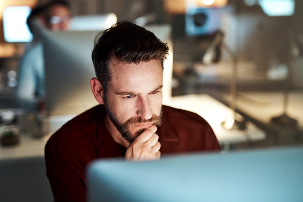 Photo of a man working at his computer