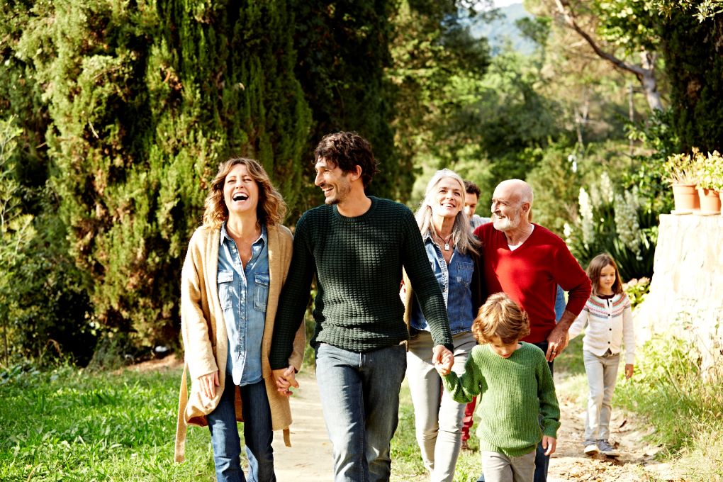 Photo for an article about inheritance, showing grandparents, parents and kids taking a walk together