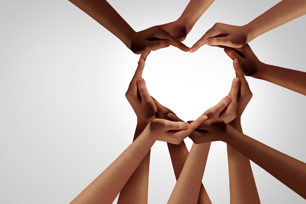 Montage of various hands forming a heart.