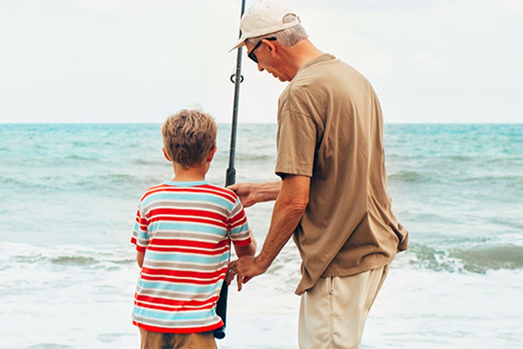 Grandfather fishing with his grandson 