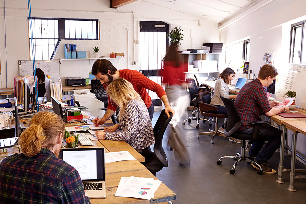 Photo of people working in an open space office 