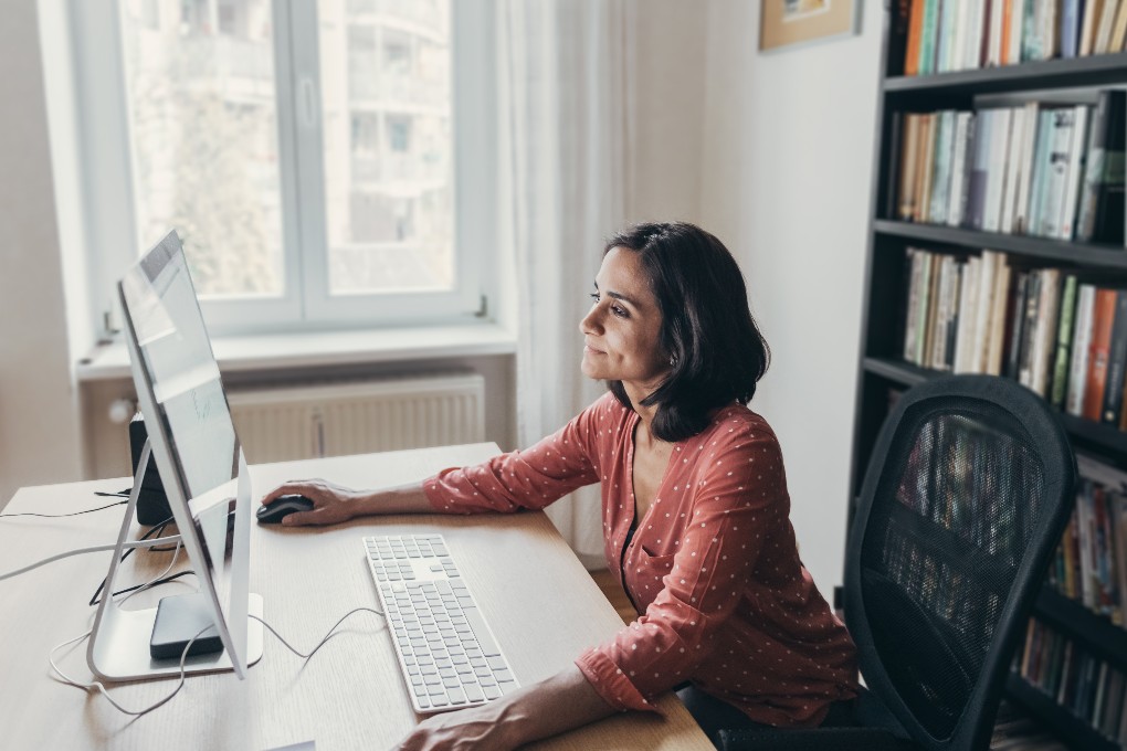 Photo of a woman sitting in front of her computer 
