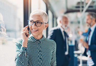 Photo of a woman in professional attire speaking on the phone in an office in Florida 
