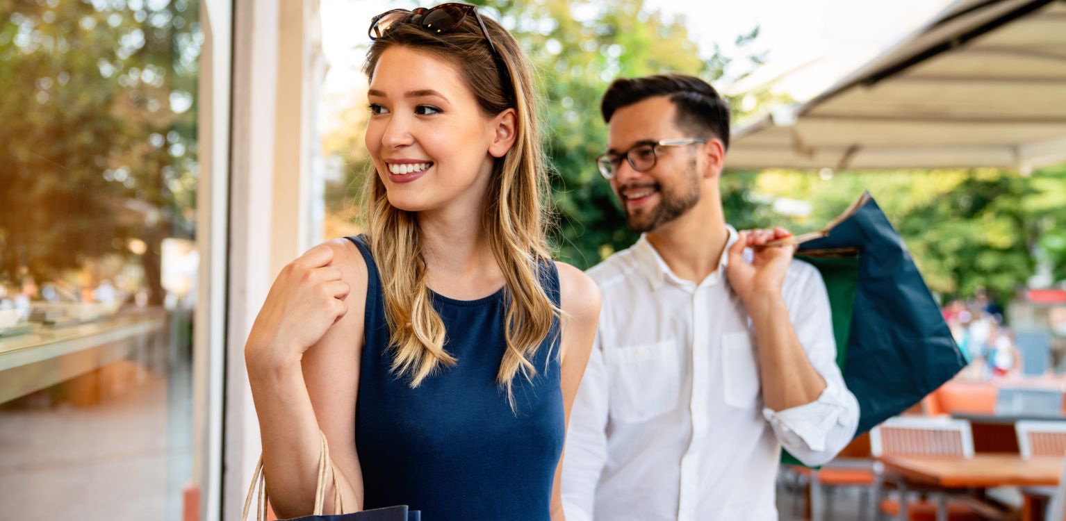 Photo of two people carrying shopping bags