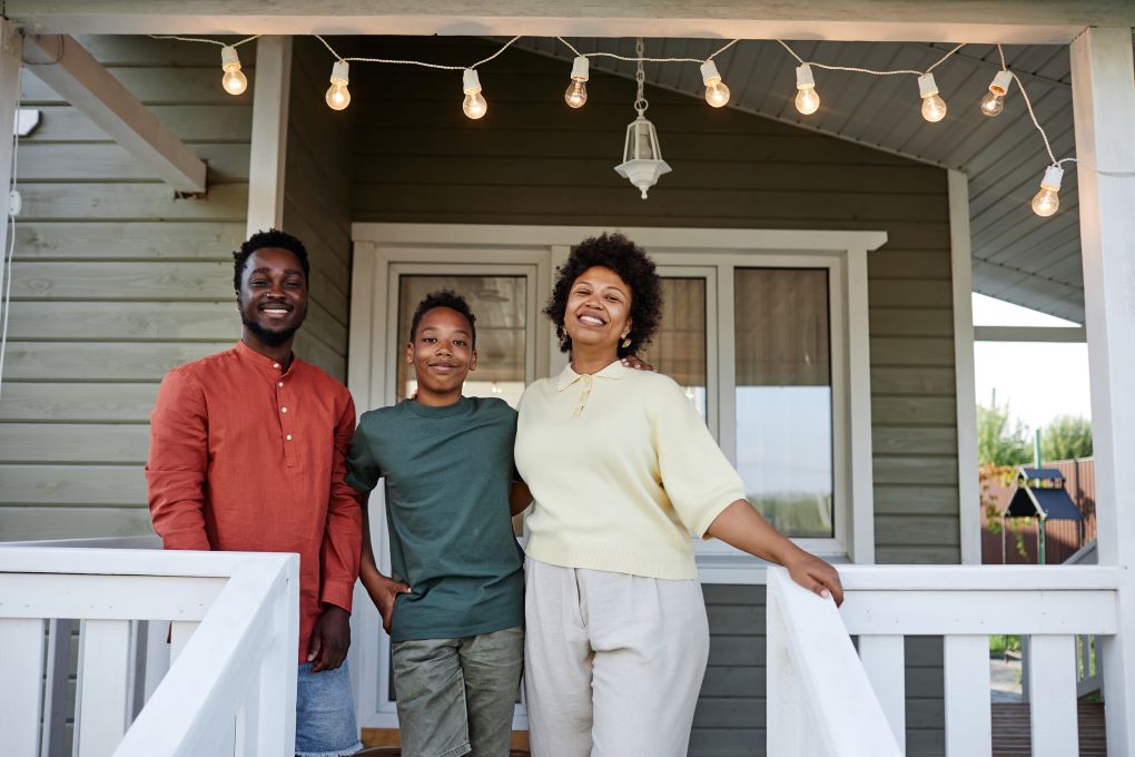 Photo of a family in front of a house