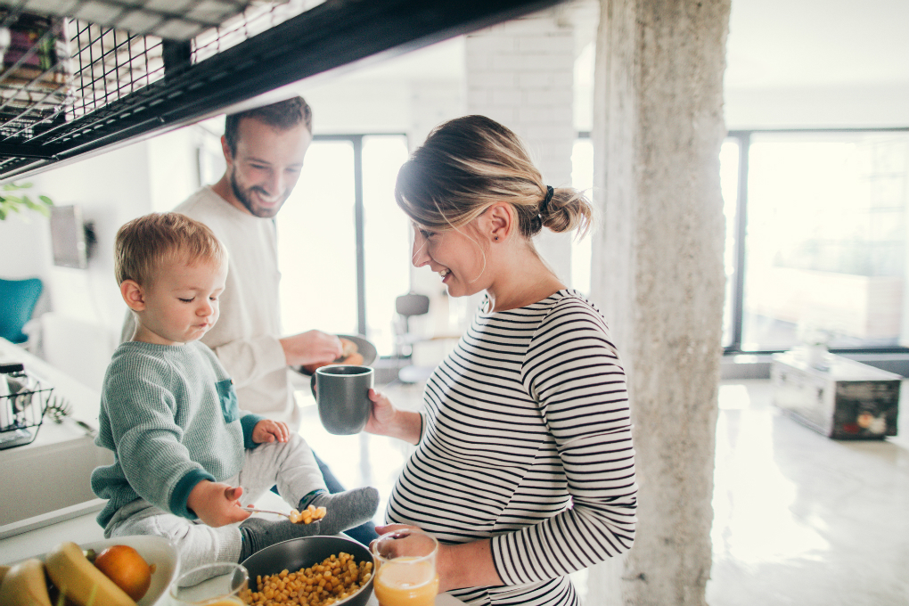 Photo of a couple and their son standing in their kitchen