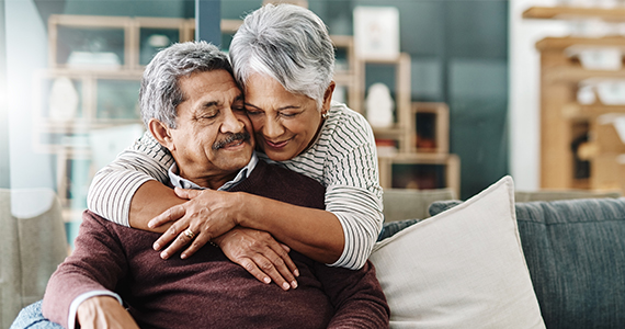 Photo of a retired couple hugging each other 