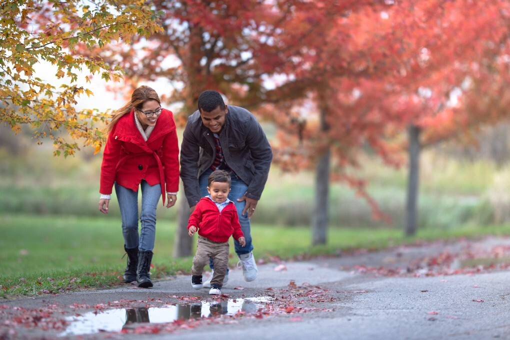Photo of a couple and their baby outside