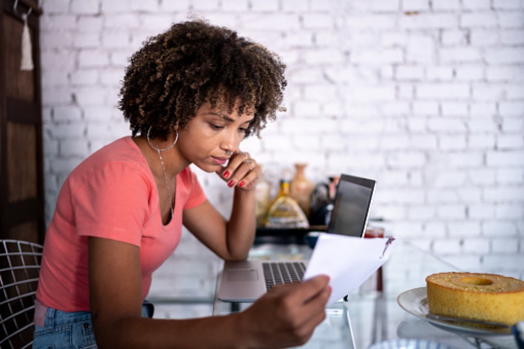 Photo of a woman reading a paper