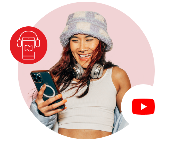 Photo of a young person smiling while looking at their phone with the YouTube logo