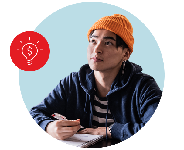 Photo of a young adult sitting in class taking notes 